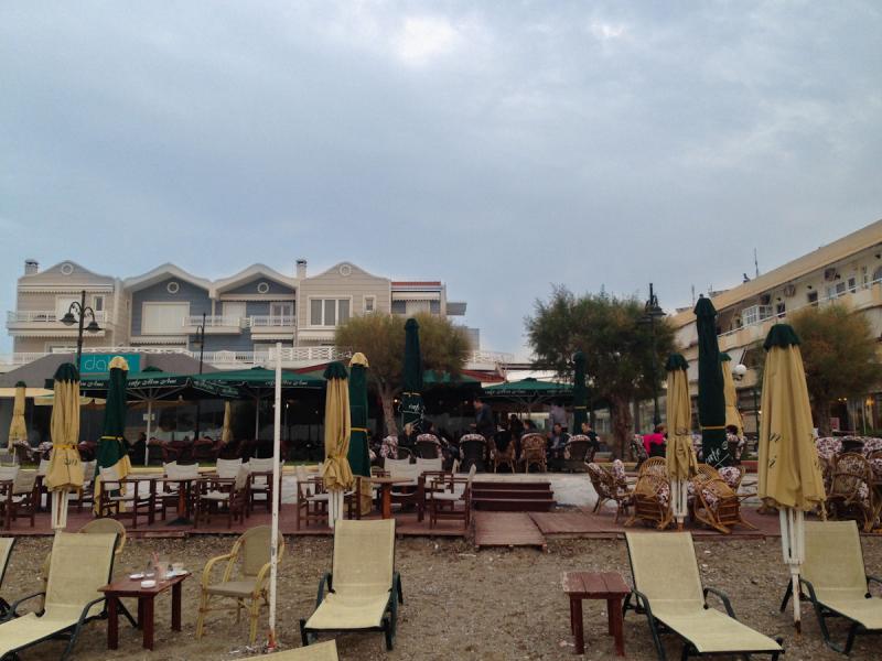 Autumn view of cafes and restaurants above Kalamia beach in Corinth.